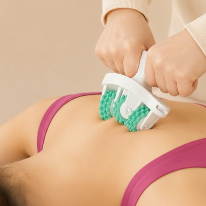 Person using a green and white massage roller on their back against a beige background